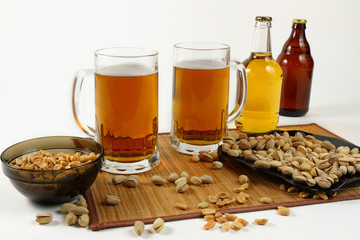 Still life with beer mugs and pistachios in light colors
