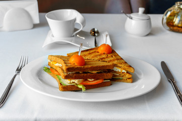delicious Panini sandwich with cherry tomatoes in the restaurant