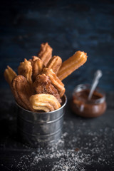 Traditional Mexican dessert churros in the metal basket,selective focus