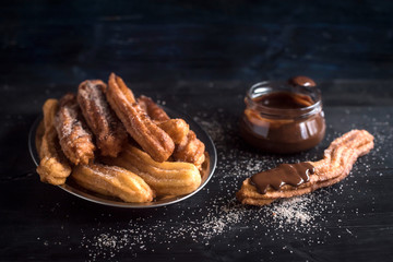 Sweet homemame churros with chocolate,selective focus