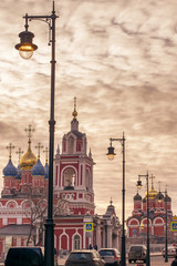 Obraz premium European landmark and tourist center of Moscow on a background of scarlet red sky of sunset and the domes of the churches