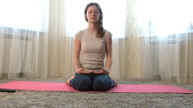 Woman of yoga at home. Meditation. The concept of fitness, sports, training and lifestyle.