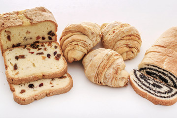 Homemade roll with poppy seeds and sweet bread with grains of grapes