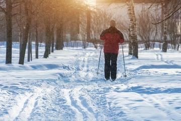 Man woman on skiing in winter in a park on a frosty day.