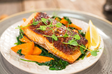 Salmon steak with carrot and spinach
