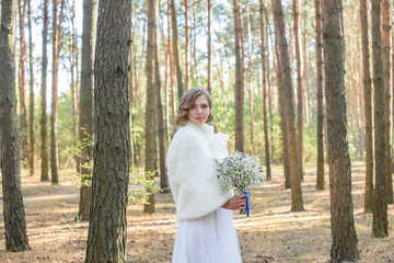 Portrait of a woman in wedding dress with white flowers. the bride holding a bouquet