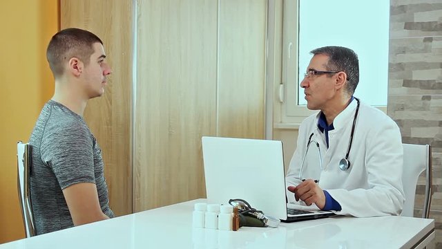 Doctor Talks With Young Athlete