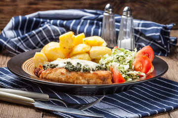 Fried chicken fillet with spinach and cheese.