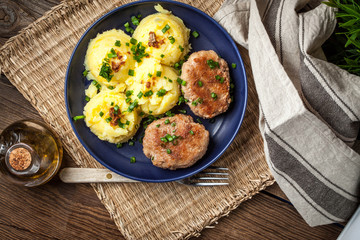 Meatballs served with boiled potatoes.