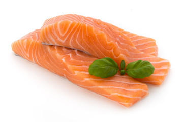 Fresh salmon fillet with basil on the white background.