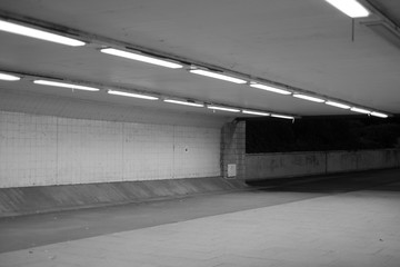 Pedestrian underpass at night with fluorescent lighting
