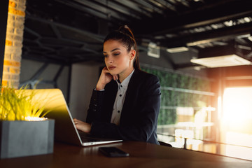 Attractive businesswoman using laptop computer.