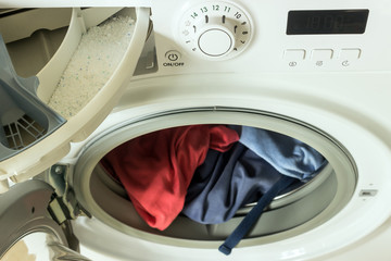 Clothing in washing machine.  Concept- laundry, housework, house cleaning.