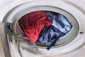 Clothing in washing machine.  Concept- laundry, housework, house cleaning.