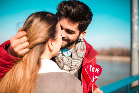 Young Couple Almost Kissing Outdoors.