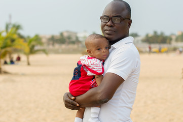 portrait of a young man and his baby