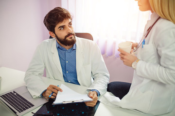 Male and female doctors discussing.