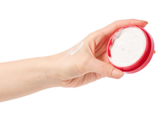 Face body cream in a red jar in hand