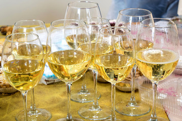 Seven glasses of champagne on the wooden table
