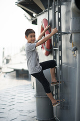 Fototapeta na wymiar Boy driving war ship military at the national museam