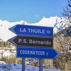 Panoramic view of the winter alps mountain Valle d'Aosta with street signs to major ski resorts in the area