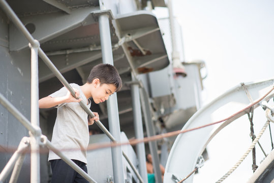 Boy  driving war ship military at the national museam