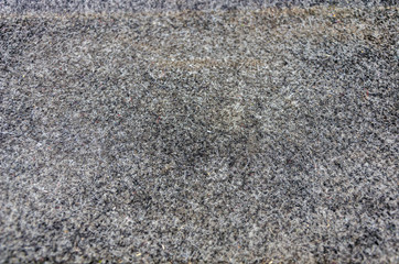 texture of a fleecy dark gray carpet