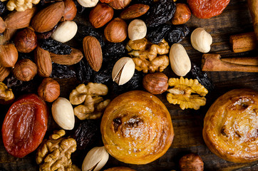 Nuts, dried fruits, pistachios and homemade cookies are scattered from the bag on the table