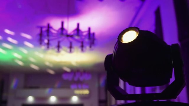 Rainbow colors of stroboscopic light motion movement with illuminated pattern on the roof of a celebration wedding hall - happy celebration atmosphere