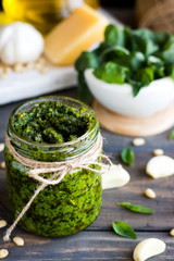 Fresh homemade pesto sauce and ingredients to it
