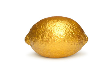 Gold lemon isolated on white background. Creative concept with fruit