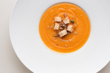Pumpkin cream soup in white plate