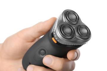 Man holding electric shaver on white background