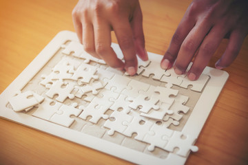 Close-up Photo Of Businesspeople Holding Jigsaw Puzzle