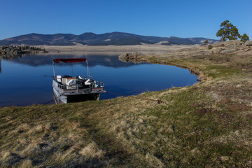 Pontoon Boat at the edge of Eleven Mile Reservoir, Colorado USA.