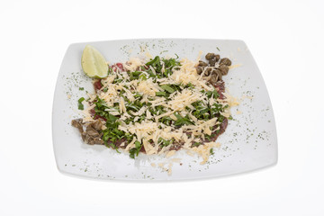 beef carpaccio with capers, parmesan, arugula, lemon and olive oil.