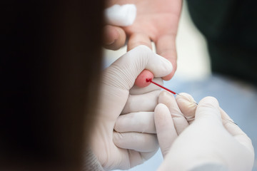 Health and Medical concept. Taking blood on finger for analysis test in clinical. Blood test is...