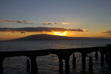 Mala Pier at sunset with Lanai in the background.
