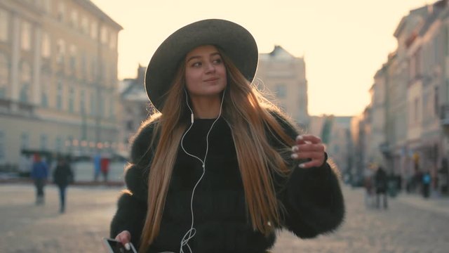 Young girl Going the city and listening to music on the phone