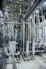Modern brewery interior. System of pipelines, pumps and vats