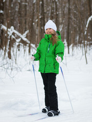 She is in a good mood on the slopes in the winter forest.