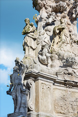 Fototapeta na wymiar Kremnica - The Safarikovo square and detail of the baroque Holy Trinity column with the St. Sebastian and St. Joseph by Dionyz Ignac Stanetti (1765 - 1772).