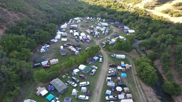 Large group of people in the mountains camping.