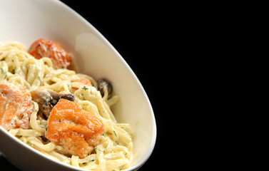Fried Salmon Penne tube-shaped pasta with mushrooms tarragon and cheese creamy sauce