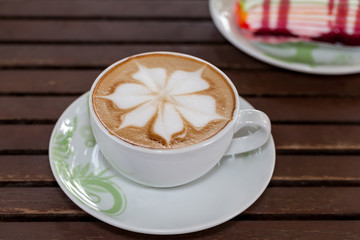 Coffee leaf and place the cake on a wooden table.