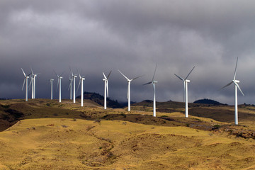 A wind farm rises above Honoapillani Highway 30 as it passes along Papawai Point on Maalaea Bay on...