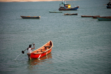 Sawantwadi, Maharashtra, India, Jan 2013, man rowing a boat