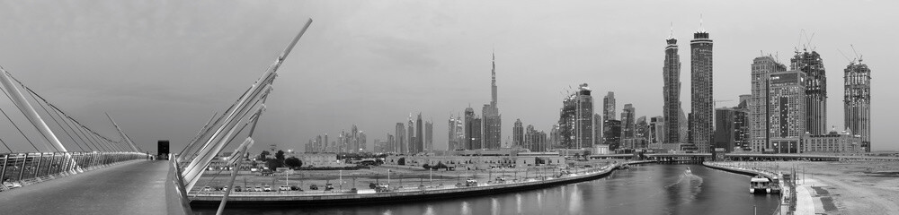 DUBAI, UAE - MARCH 27, 2017: The evening skyline with the bridge over the new Canal and Downtown.