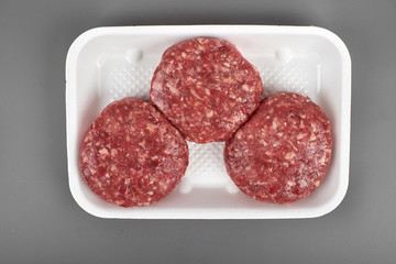 beef burgers in plastic package isolated on white background