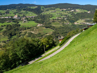 Naklejka premium View of mountain peaks and green meadow in summer landscape of Dolomiti Alps, Italy
